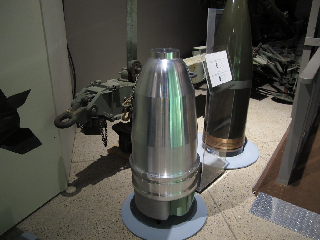 a large metal cylinder next to a green object