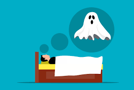 a man lying in bed with a ghost flying above him